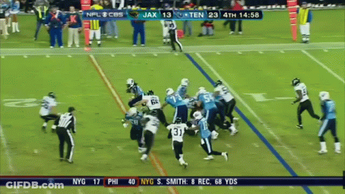 A Football Game Between The Titans And The Ravens GIF