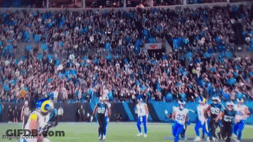A Football Game Is Being Played In A Stadium With A Large Crowd Watching . GIF