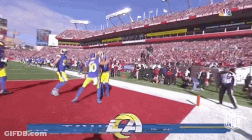 A Football Game Is Being Played In A Stadium With A Lot Of People In The Stands . GIF