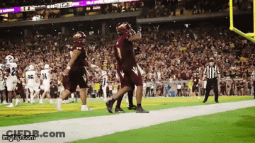 A Football Game Is Being Played In A Stadium With A Referee Watching GIF