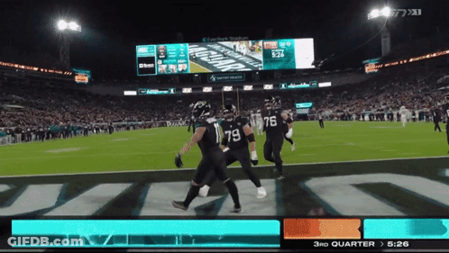 A Football Game Is Being Played In A Stadium With A Scoreboard That Says Jaguars On It GIF