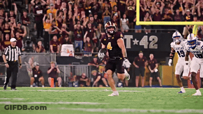 A Football Game Is Being Played In Front Of A Banner That Says Kansas GIF