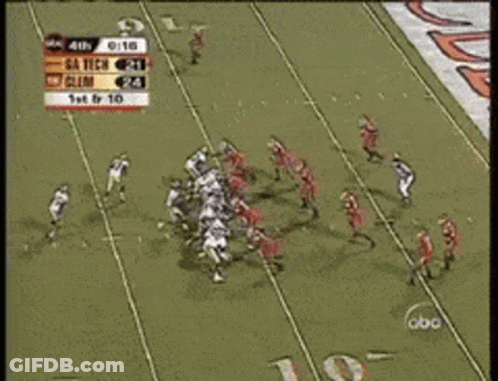 A Football Game Is Being Played In Front Of A Crowd GIF