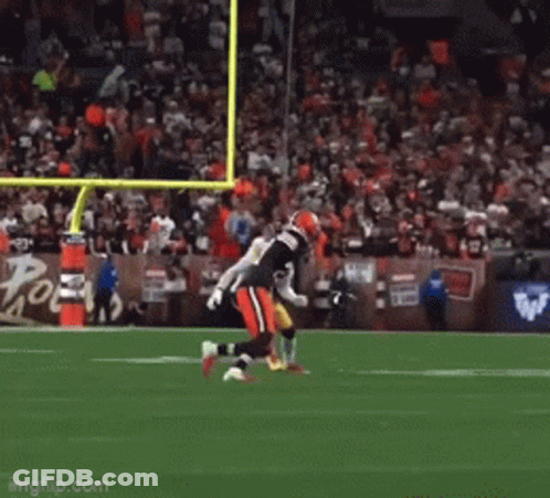 A Football Game Is Being Played In Front Of A Large Crowd GIF