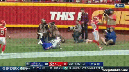 A Football Game Is Being Played In Front Of A Sign That Says This ! GIF