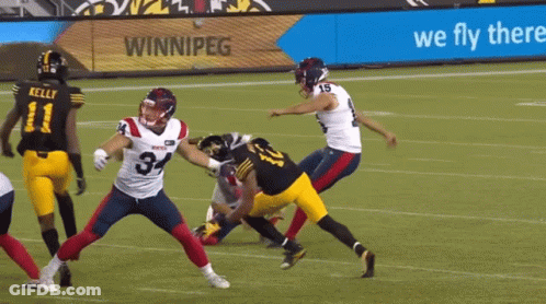 A Football Game Is Being Played In Front Of A Sign That Says We Fly There GIF
