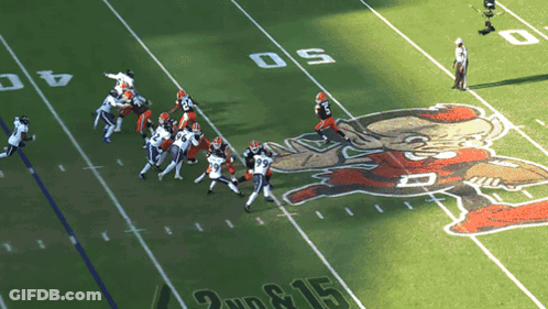 A Football Game Is Being Played On A Field That Has The Number 15 On It GIF