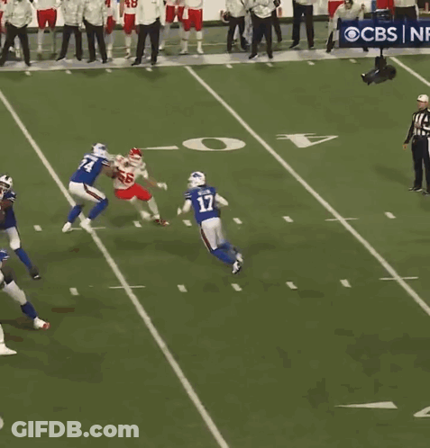 A Football Game Is Being Played On A Field With A Cbs Banner In The Background GIF