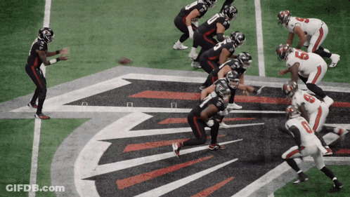 A Football Game Is Being Played On A Field With The Falcons Logo In The Background GIF