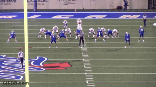 A Football Game Is Being Played On A Field With The Number 50 On The Sidelines GIF