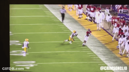 A Football Game Is Being Shown On A Large Screen With The Hashtag @Crimsonclio GIF