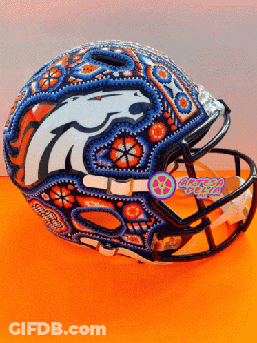 A Football Helmet With A Denver Broncos Logo Painted On The Front GIF