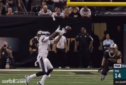 A Football Player Catches A Ball During A Game With The Number 14 On The Bottom Right GIF