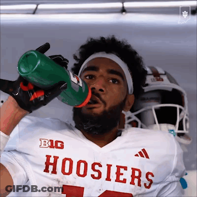 A Football Player Drinking From A Gatorade Bottle GIF
