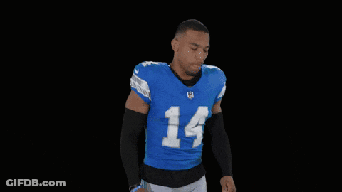 A Football Player Flexes His Muscles In A St Brown 14 Jersey GIF