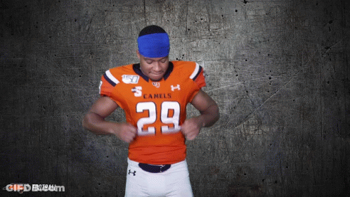 A Football Player For The Camels Is Adjusting His Jersey GIF