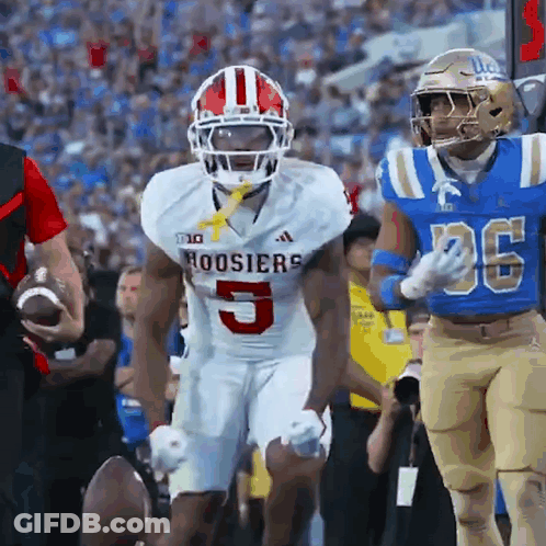 A Football Player For The Hoosier 'S Is Running With The Ball GIF