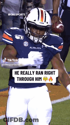 A Football Player From The Auburn Tigers Is Holding A Football GIF