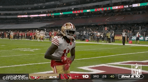 A Football Player In A 49Ers Uniform Stands On A Field GIF