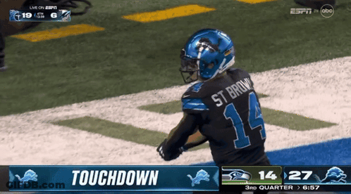 A Football Player In A Black Jersey With The Number 14 On The Back GIF