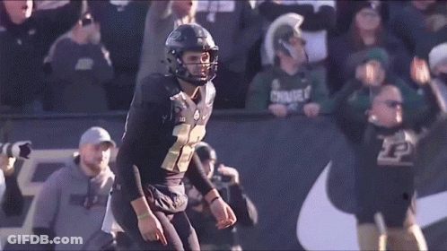 A Football Player In A Black Uniform With The Number 22 On It GIF