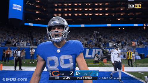 A Football Player In A Blue Jersey With The Number 89 On It GIF