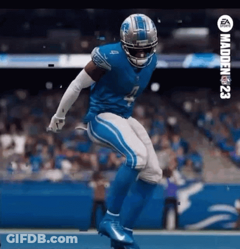 A Football Player In A Blue Uniform Is Jumping In The Air On The Field . GIF
