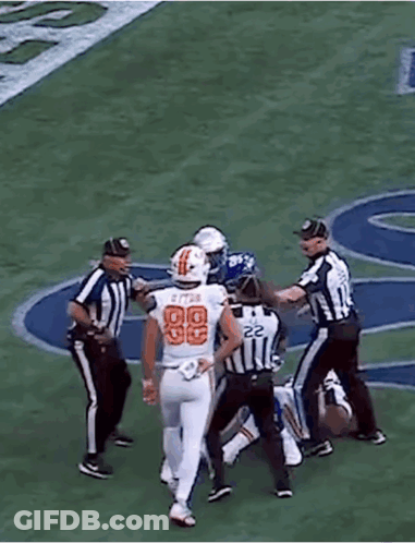 A Football Player In A Blue Uniform With The Number 99 On It GIF