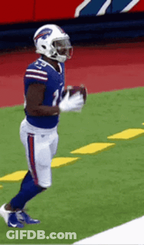 A Football Player In A Buffalo Bills Uniform Is Holding A Football GIF