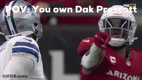 A Football Player In A Cowboys Uniform Is Pointing At Another Player In A Cardinals Uniform GIF