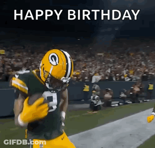 A Football Player In A Green Bay Packers Uniform Is Running With The Ball . GIF