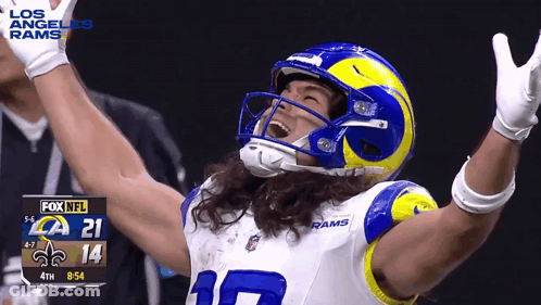 A Football Player In A Los Angeles Rams Uniform Is Celebrating With His Arms In The Air GIF