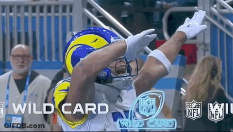 A Football Player In A Rams Helmet Is Celebrating A Touchdown During A Game . GIF