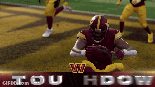 A Football Player In A Red And Yellow Uniform Holds A Ball In His Hands GIF