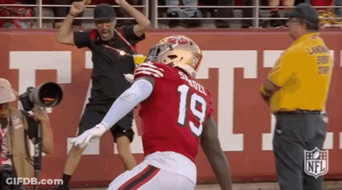 A Football Player In A Red Jersey With The Number 19 On It GIF