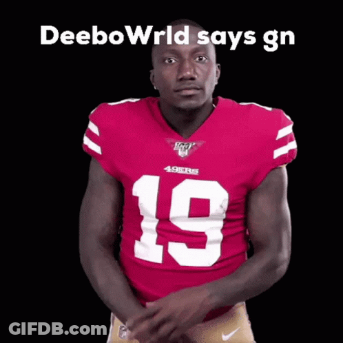 A Football Player In A Red Jersey With The Number 19 On It Is Pointing At The Camera . GIF