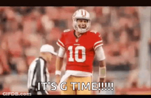 A Football Player In A Red Uniform Is Standing Next To A Referee On The Field . GIF
