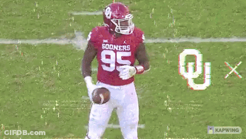 A Football Player In A Red Uniform With The Number 35 On It GIF