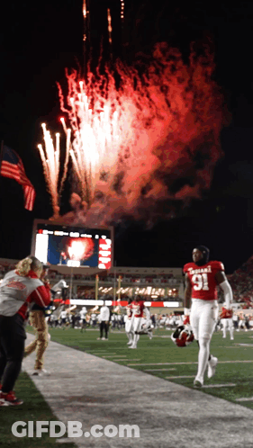 A Football Player In A Red Uniform With The Number 91 On It GIF