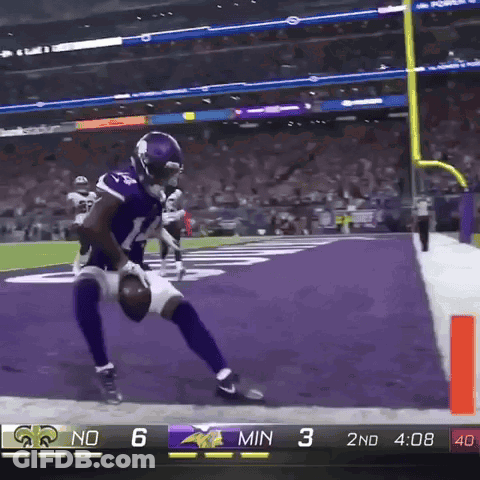 A Football Player In A Vikings Uniform Runs Towards The Goal Line GIF
