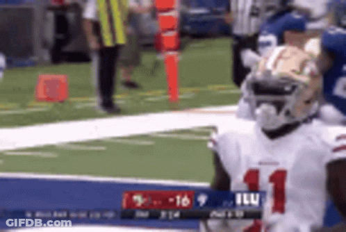 A Football Player In A White Jersey With The Number 11 On It Is Standing On A Field . GIF