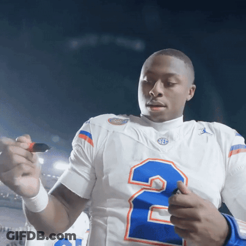 A Football Player In A White Jersey With The Number 2 On It GIF