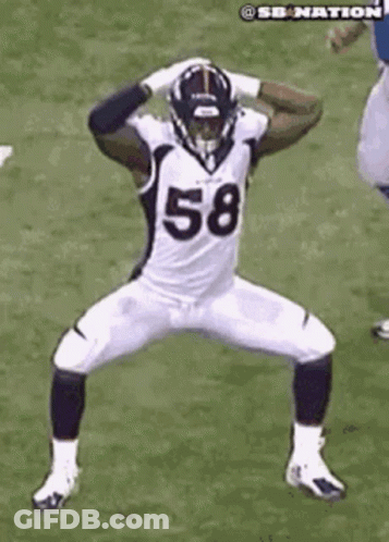 A Football Player In A White Uniform With The Number 58 On It Is Dancing On A Field . GIF