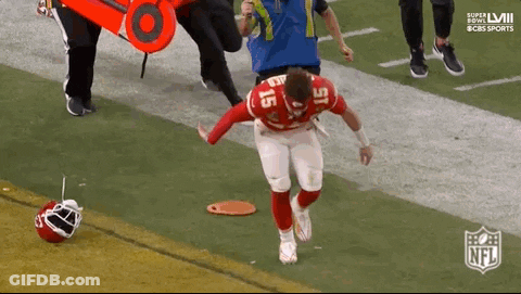 A Football Player Is Being Helped Off The Field By A Nurse . GIF