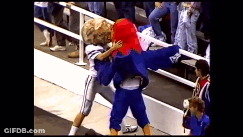 A Football Player Is Being Tackled By A Mascot That Has The Letter A On It GIF