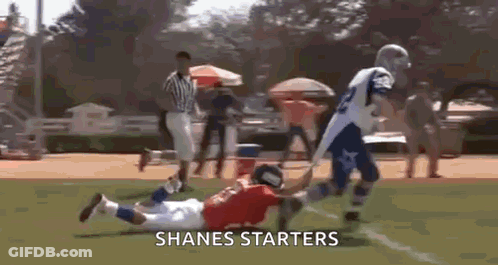 A Football Player Is Being Tackled By Another Player On A Field With The Words Shanes Starters On The Bottom . GIF