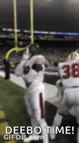 A Football Player Is Catching A Ball On The Field While Another Player Says Deebo Time . GIF
