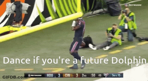 A Football Player Is Dancing On The Field With The Words Dance If You 'Re A Future Dolphin Below Him GIF