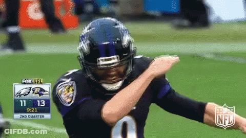 A Football Player Is Doing A Dab On The Field GIF