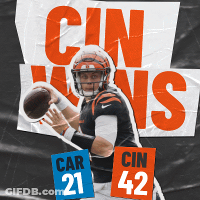A Football Player Is Holding A Ball In Front Of A Sign That Says Cin Wins GIF